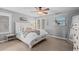 Inviting bedroom featuring neutral tones, plush bedding, shuttered windows, and coastal-themed decor at 6132 S Boston Cir, Greenwood Village, CO 80111
