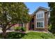 Charming two-story brick home with well-maintained landscaping and attached garage at 6132 S Boston Cir, Greenwood Village, CO 80111
