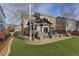 Lush backyard features a covered patio, artificial grass, and privacy, ideal for relaxing and entertaining at 11701 Elkhart St, Commerce City, CO 80603