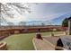 Backyard shows landscaping, artificial grass, and outdoor seating area at 11701 Elkhart St, Commerce City, CO 80603