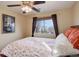 Inviting bedroom with patterned bedding, fan and framed artwork, creating cozy ambiance at 11701 Elkhart St, Commerce City, CO 80603