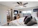 Serene bedroom with a ceiling fan, plush bedding, and an ensuite bathroom at 11701 Elkhart St, Commerce City, CO 80603