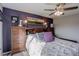 Comfortable bedroom featuring a ceiling fan and unique decor at 11701 Elkhart St, Commerce City, CO 80603