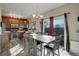 Inviting dining area adjacent to the kitchen features wood floors and a large sliding glass door with views to the backyard at 11701 Elkhart St, Commerce City, CO 80603