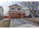 Charming two-story home with a well-maintained lawn and a spacious driveway at 11701 Elkhart St, Commerce City, CO 80603