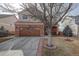 Charming two-story home with a brick facade, a well-maintained lawn, and a two-car garage at 11701 Elkhart St, Commerce City, CO 80603