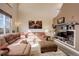 Spacious living room with a plush sectional couch and a built-in entertainment center at 11701 Elkhart St, Commerce City, CO 80603