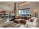Bright living room with a cozy fireplace, plush seating, and an abundance of natural light at 11701 Elkhart St, Commerce City, CO 80603