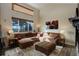 Spacious living room with high ceilings, large windows, a plush sectional sofa, and stylish decor at 11701 Elkhart St, Commerce City, CO 80603