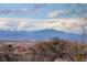 Scenic view of the mountains in the distance with a neighborhood on the horizon at 11701 Elkhart St, Commerce City, CO 80603