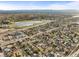An aerial view of the neighborhood, featuring a tranquil lake and easy highway access at 4942 Grove St, Denver, CO 80221
