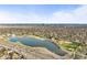 The aerial view highlights a serene lake and convenient highway access set against the city skyline at 4942 Grove St, Denver, CO 80221