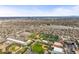 Scenic aerial view of the area with sports fields, a lake, and a glimpse of the city skyline at 4942 Grove St, Denver, CO 80221