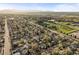 An aerial view showcasing the neighborhood's houses and roads, set against a mountain backdrop at 4942 Grove St, Denver, CO 80221