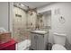 Modern bathroom showcasing a tiled shower with a glass door and updated fixtures at 4942 Grove St, Denver, CO 80221