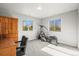 Bedroom with treadmill, wooden furniture, carpeted floor, and two windows at 4942 Grove St, Denver, CO 80221