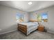 Bedroom with two windows, wooden furniture and carpeted floor at 4942 Grove St, Denver, CO 80221