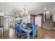 Elegant dining area adjacent to the kitchen with stylish chandelier and seating for six at 4942 Grove St, Denver, CO 80221
