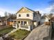 Charming two-story home featuring a welcoming front porch and well-maintained landscaping at 4942 Grove St, Denver, CO 80221