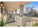 Inviting covered porch with classic columns, offering a relaxing outdoor space at 4942 Grove St, Denver, CO 80221