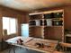 Spacious garage with custom shelving, offering ample storage and workspace, and natural light through a window at 4942 Grove St, Denver, CO 80221