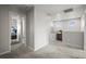 Hallway with carpeted floor and entrances into bedrooms and bathrooms at 4942 Grove St, Denver, CO 80221