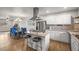 Modern kitchen with stainless steel appliances, a center island, and ample counter space at 4942 Grove St, Denver, CO 80221
