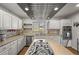 Stylish kitchen with stainless steel appliances, granite countertops, and a functional center island at 4942 Grove St, Denver, CO 80221
