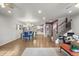 Open-concept living space with hardwood floors, seamlessly connecting the dining and kitchen areas at 4942 Grove St, Denver, CO 80221