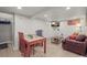 Living room with dining table, chairs, television, and lounge at 4942 Grove St, Denver, CO 80221