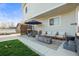 Cozy patio featuring a fire pit, comfortable seating, grill, and privacy screen at 4942 Grove St, Denver, CO 80221
