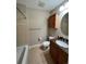 Cozy bathroom with a shower-tub combo, granite vanity, and wood-look tile flooring at 1441 Central # 305, Denver, CO 80211