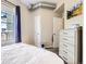 Bright bedroom featuring a large window with blinds, neutral walls, and modern furnishings at 1441 Central # 305, Denver, CO 80211