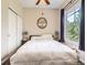Inviting bedroom featuring ample natural light, ceiling fan, plush bedding, and closet at 1441 Central # 305, Denver, CO 80211