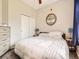 Comfortable bedroom with plush bedding, closet, ceiling fan, and decorative tree art at 1441 Central # 305, Denver, CO 80211