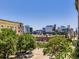 Scenic city view from a balcony, featuring cityscape, trees, and street activity below on a clear day at 1441 Central # 305, Denver, CO 80211
