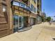 Modern brick building with large windows, showcasing the building's entrance and street-level commercial space at 1441 Central # 305, Denver, CO 80211