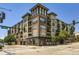 Modern multi-story building with brick and siding, showcasing a contemporary urban living space with many windows and street access at 1441 Central # 305, Denver, CO 80211