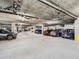 Spacious parking garage with ample parking spaces and visible ceiling piping at 1441 Central # 305, Denver, CO 80211
