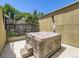 Private outdoor hot tub on a patio, perfect for relaxation and entertaining, surrounded by fencing and greenery at 1441 Central # 305, Denver, CO 80211