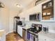Functional kitchen with white cabinets, stainless steel appliances, and sleek countertops at 1441 Central # 305, Denver, CO 80211
