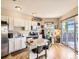 Bright kitchen with white cabinetry, stainless steel appliances, hardwood floors, and access to outdoor space at 1441 Central # 305, Denver, CO 80211