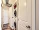 In-unit laundry closet in hallway with stacked washer and dryer at 1441 Central # 305, Denver, CO 80211