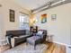 Cozy living room featuring hardwood floors, a stylish rug, and comfortable seating with modern decor at 1441 Central # 305, Denver, CO 80211