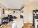 Open living area with hardwood floors, featuring a comfortable seating area, a versatile kitchen island, and good lighting at 1441 Central # 305, Denver, CO 80211