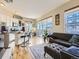Open-concept living space with a kitchen, living area, and balcony access for easy indoor-outdoor flow at 1441 Central # 305, Denver, CO 80211
