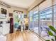 Bright, open living space with access to a private patio, featuring hardwood floors and a modern workspace at 1441 Central # 305, Denver, CO 80211