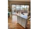 Bright room featuring an island and patio with outside view at 1441 Central # 305, Denver, CO 80211