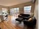 Bright living room with hardwood floors, modern furnishings, and a sliding glass door to a balcony at 1441 Central # 305, Denver, CO 80211