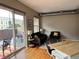 Well-lit living room with modern decor, cozy seating, and access to an outdoor patio at 1441 Central # 305, Denver, CO 80211